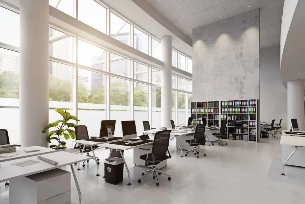 A clean modern office with desks, chairs and floor-to-ceiling windows