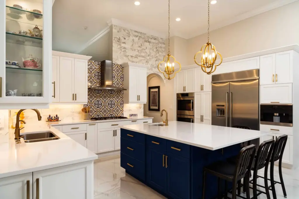 A large, freshly cleaned kitchen with a marble island and polished countertops