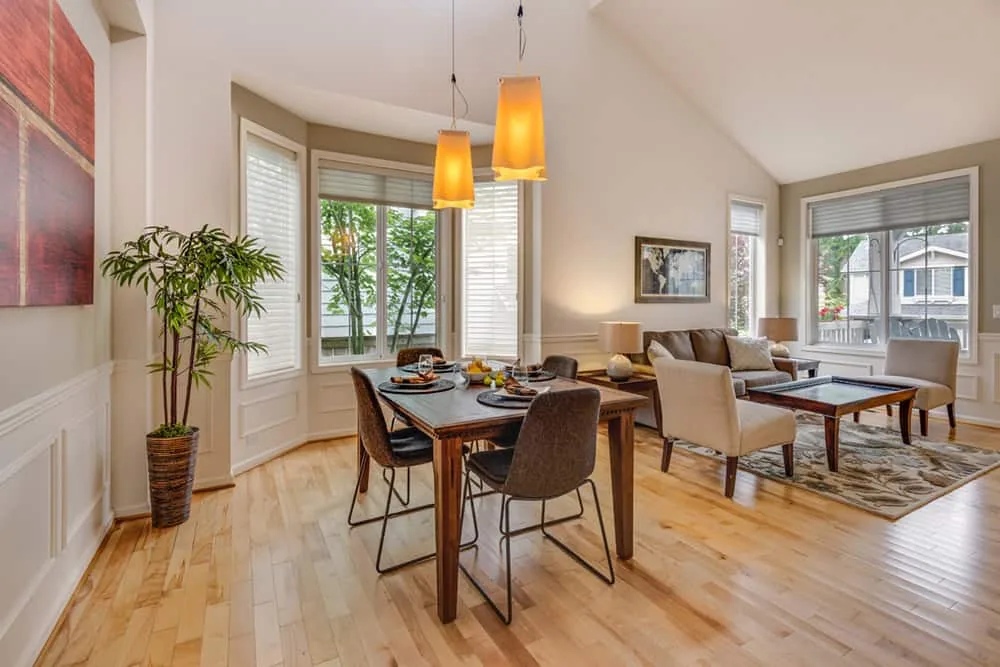 A tidy open-plan dining and living room with clean hardwood floors