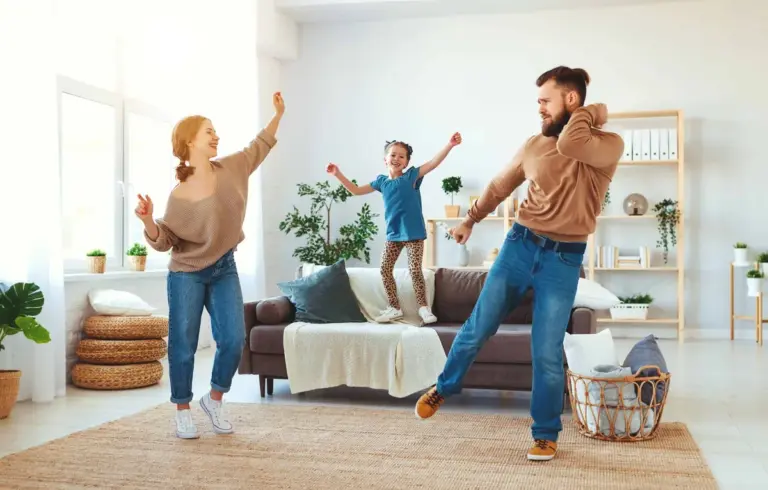 A family with a young child playing in a clean, bright living room